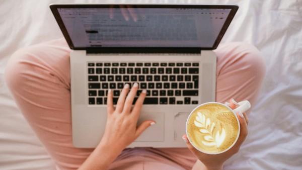 woman working on laptop, with a cup of coffee