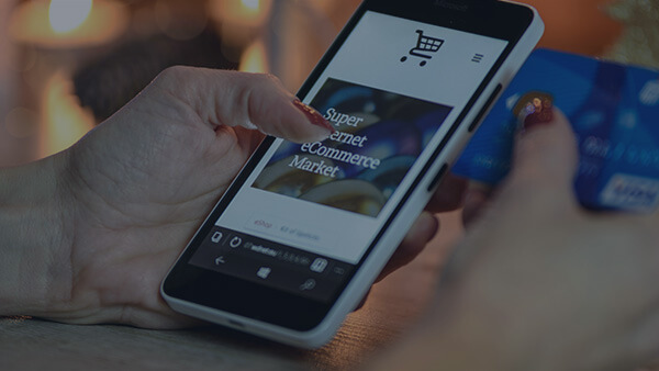 hand holding mobile phone showing shopping cart